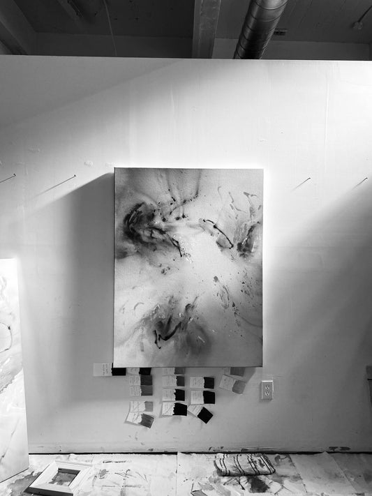 black and white image of painting on process in the studio